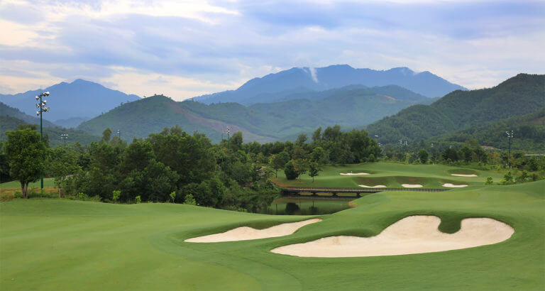 Image of the 7th hole and distant mountains at Ba Na Hills Golf Club, Da Nang, Vietnam
