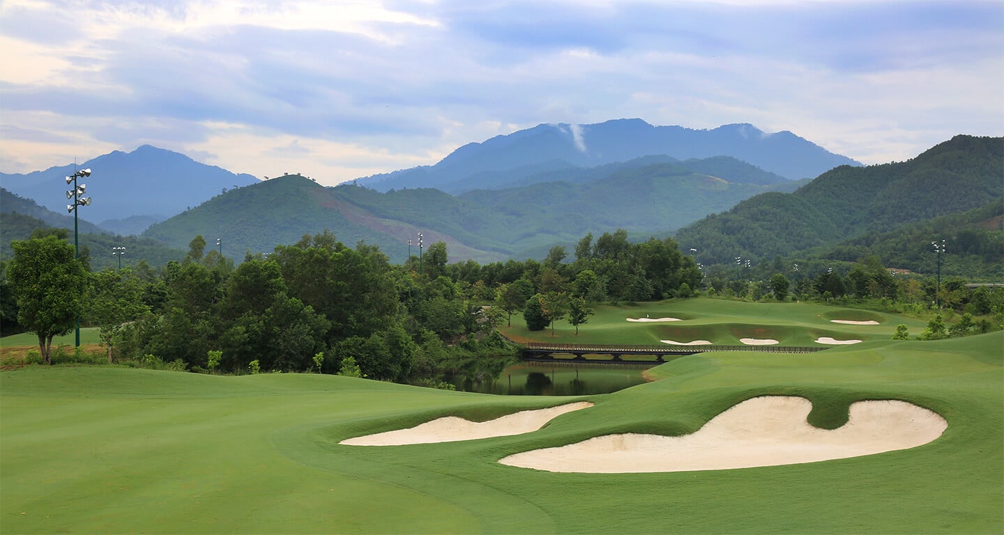 Image of the 7th hole and distant mountains at Ba Na Hills Golf Club, Da Nang, Vietnam