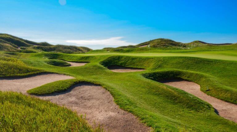 Image of bunkers littering the ground in front of the 10th green on The Irish Course at Whistling Straits