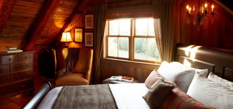 Image of the Sandhill Cabin bed bathed in sunlight, Destination Kohler, Wisconsin, USA