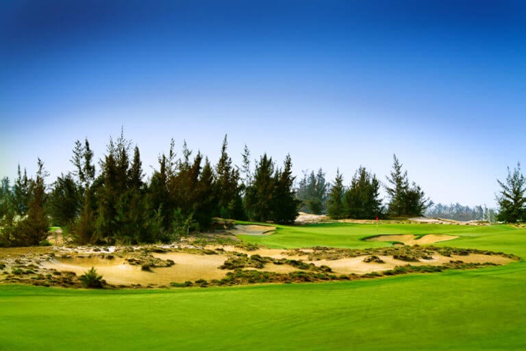 Image of rising trees surrounding the 5th hole on the BRG Golf Course in Danang, Vietnam