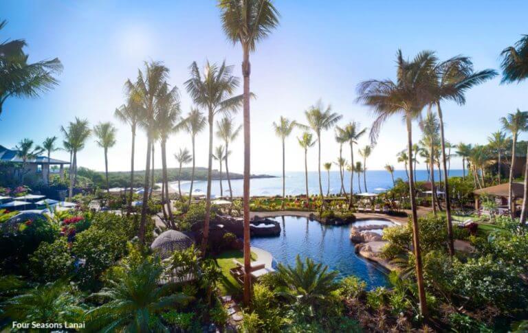 Image displaying the pool and distant beach at the Lanai Four Seasons Resort, Hawaii, USA