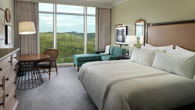 A tower king bedroom overlooks the Texan foothills at the Omni Barton Creek Golf Resort