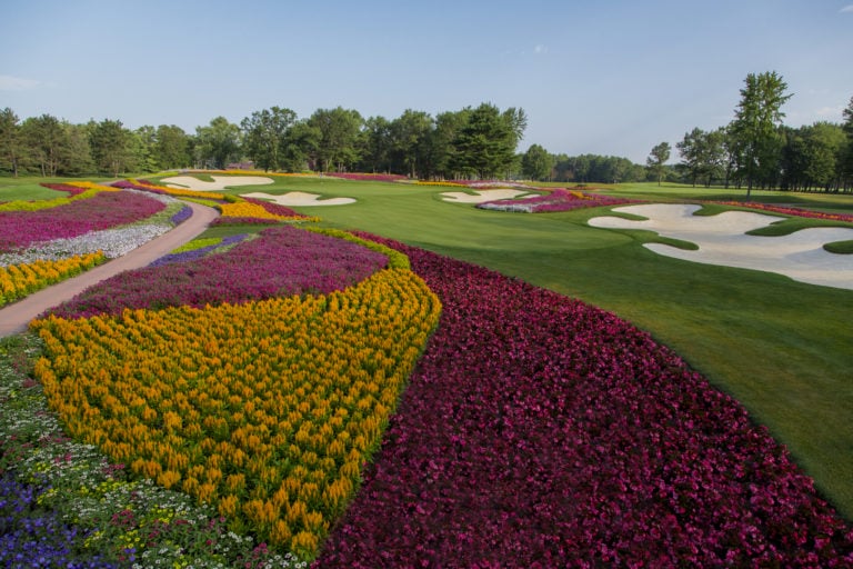 Multi-coloured garden flanks a golf hole at Sentryworld Golf Club