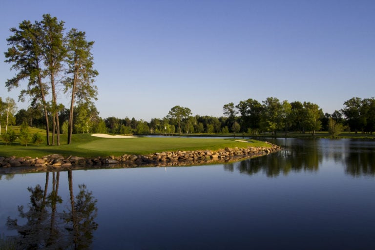 The twelfth green is surrounded on three sides by a large lake at Sentryworld Golf Course