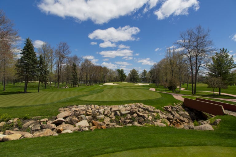The seventh fairway is separated from the tee by a stone-walled creek at Sentryworld Golf Course