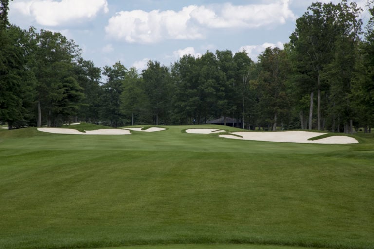 The eighth green is guarded by many bunkers at Sentryworld Golf Course