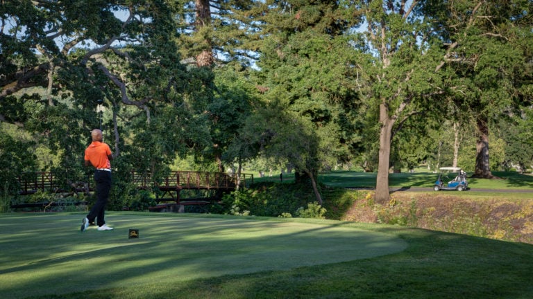 A golfer tees off on a par-three golf hole at Silverado Golf Resort