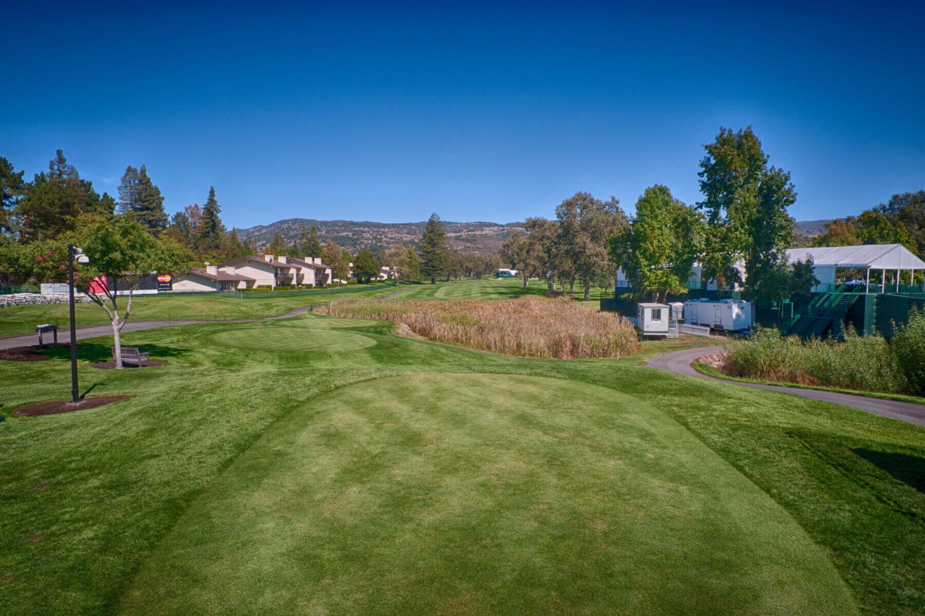 View from the first tee overlooking the distant fairway and nearby residential buildings