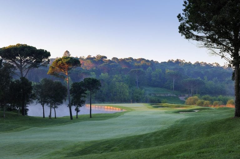 Dawn sunlight shines through trees on the Stadium course at PGA Catalunya golf resort