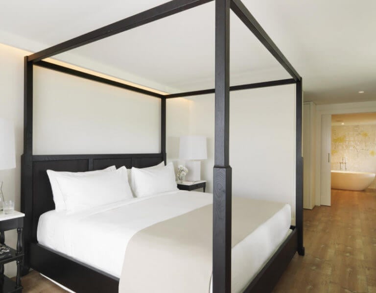 A four-poster bed and free standing bath awaits travelling golfers at PGA Catalunya Golf Resort in Spain