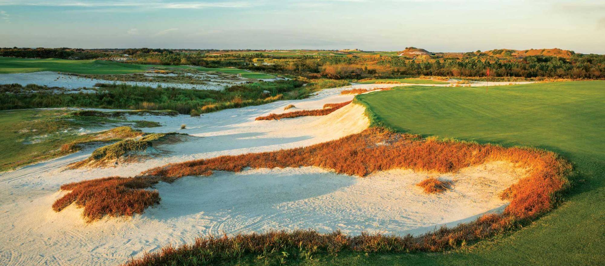 Overlooking large sandy bunkers straddling a green on the golf course at Streamsong