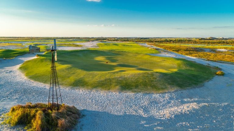 Overlooking a windmill on the Black Golf Course with distant fairways at Streamsong