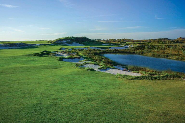 Overlooking a lake and hazardous bunkers at Streamsong Resort Black Golf Course