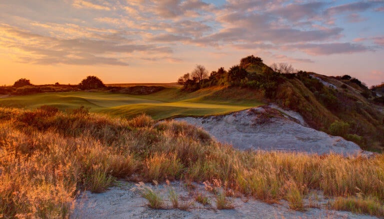 Dusk touches the golf course turning it red at Streamsong Golf Resort in Florida