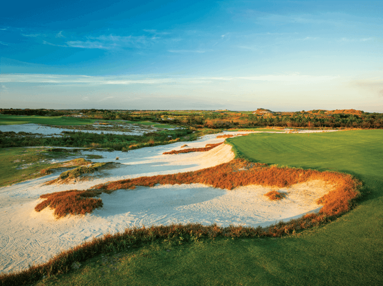 Golden dusk sunlight touches the Black Golf Course at Streamsong Resort in Florida