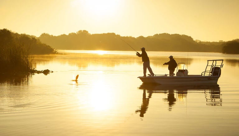 Men fish at dusk at Streamsong Resort in Florida
