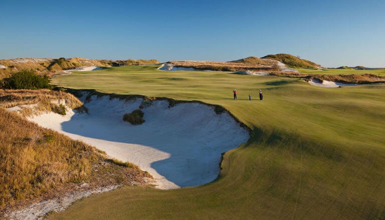 Two golfers play on the open fairways of the fifteenth hole at Streamsong Resort in Florida
