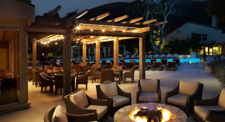 An outdoor fire pit is adjacent to the dining area at Quail Lodge Golf Resort in California