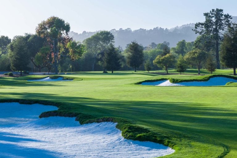 Well-manicured fairways and bunkers await golfers on the thirteenth hole at Quail Lodge Golf Course in California