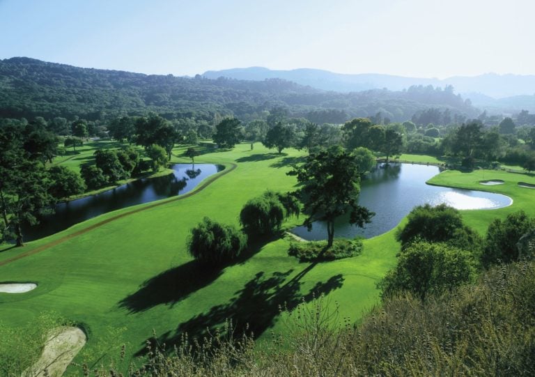 Aerial view of large trees and lakes on the Quail Lodge Golf Course in California