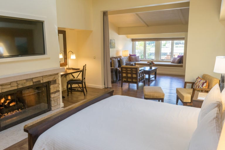 A large fireplace with writing desk and separate seating area awaits travelling golfers at Quail Lodge in California