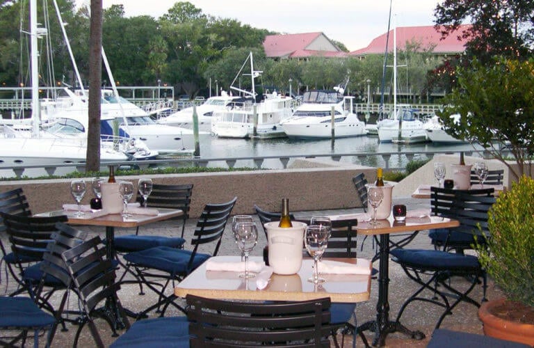Dining on a terrace overlooking boats in a marina at Palmetto Dunes Oceanfront Resort Hilton Head