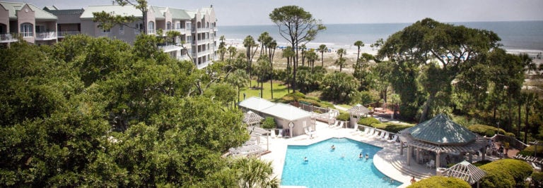 Landscape view of children playing in the resort pool at Palmetto Dunes Resort