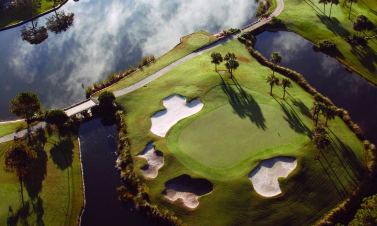Aerial view of a green and surrounding bunkers with lakes on the Dye's Valley Golf Course at TPC Sawgrass