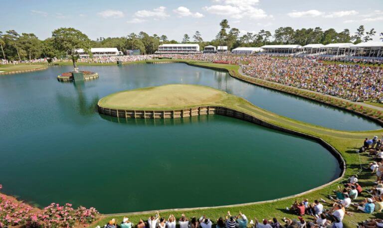 Golf fans sit on the famous seventeenth hole at TPC Sawgrass Golf Course