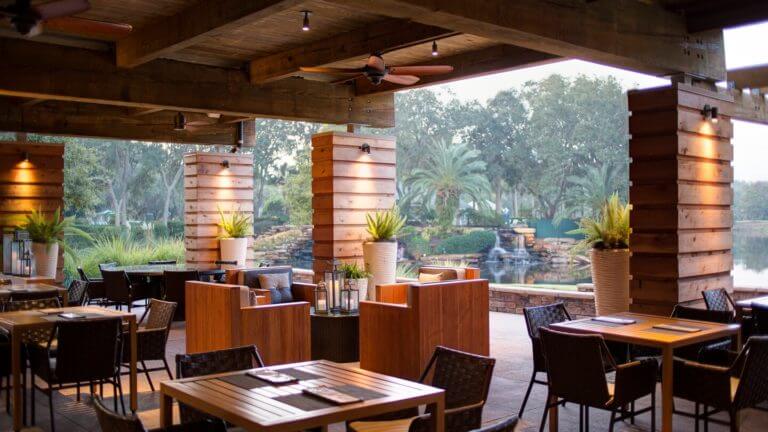 View of patio dining area and nearby lake at Sawgrass Marriott Golf Resort & Spa