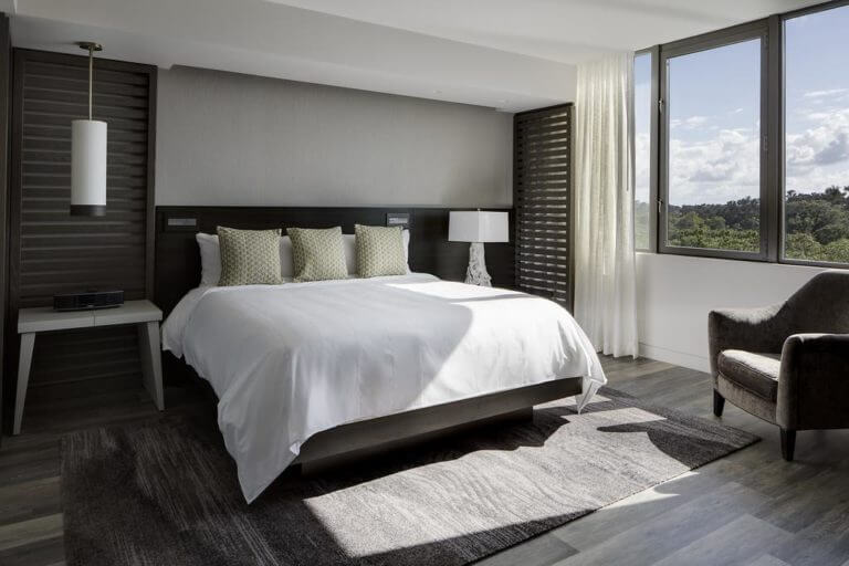 A large king bed and contemporary design features in a Marriot Suite at Sawgrass Marriott Golf Resort & Spa