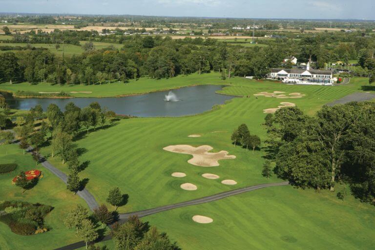 Aerial view of the dogleg tenth hole with large lake and golf clubhouse at the K Club Golf Resort in Ireland