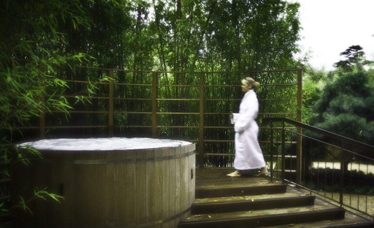A woman approaches an outdoor spa at The K Club Resort in Ireland