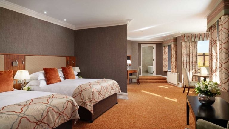 Twin beds are separated from the room in a suite at Slieve Donard Hotel