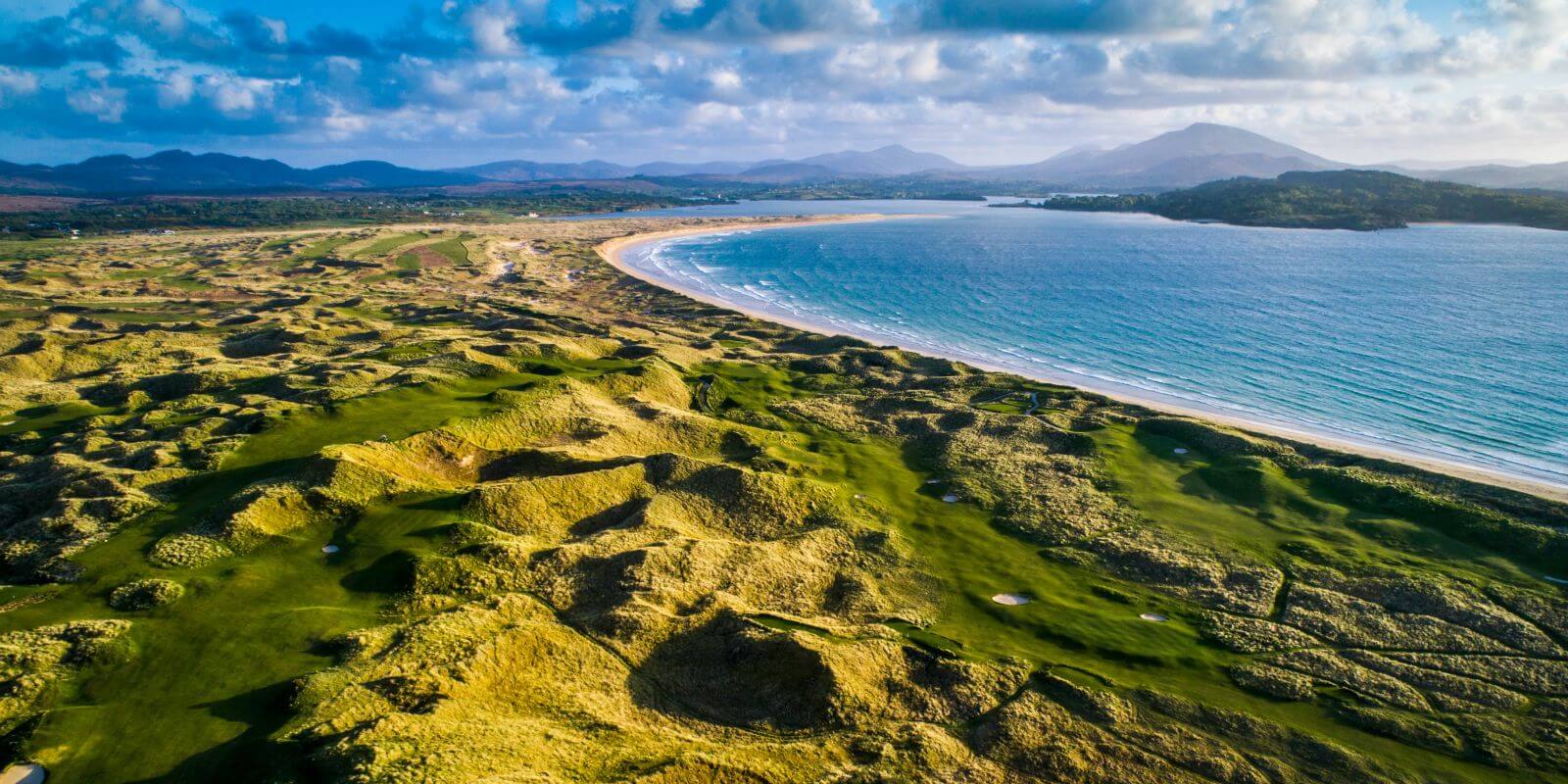 Aerial view of the setting sun bathing the golf precinct in golden light at Rosapenna Golf Resort, Ireland