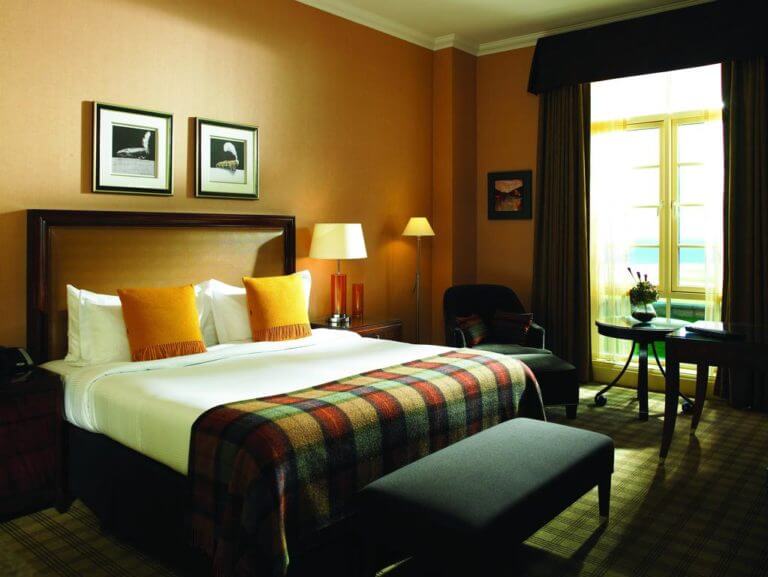 Interior view of a double bed and contemporary furniture at The Fairmont Hotel, St Andrews