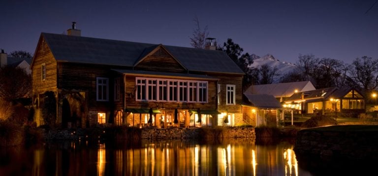 A twilight view of the Millhouse Restaurant on the waterfront in New Zealand's Millbrook Resort