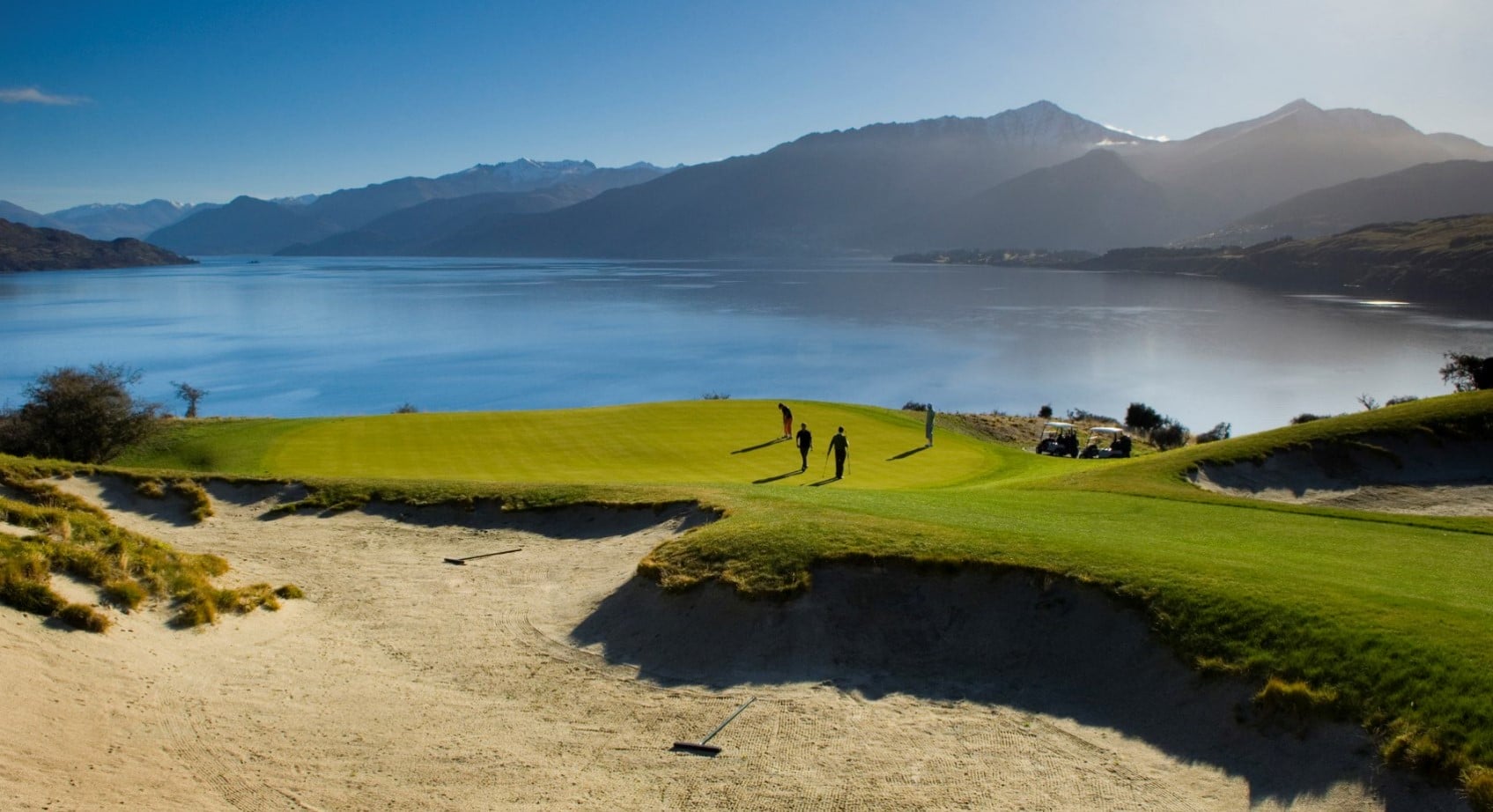Image of golfers on a putting green at Jack's Point Golf Course in New Zealand's South Island