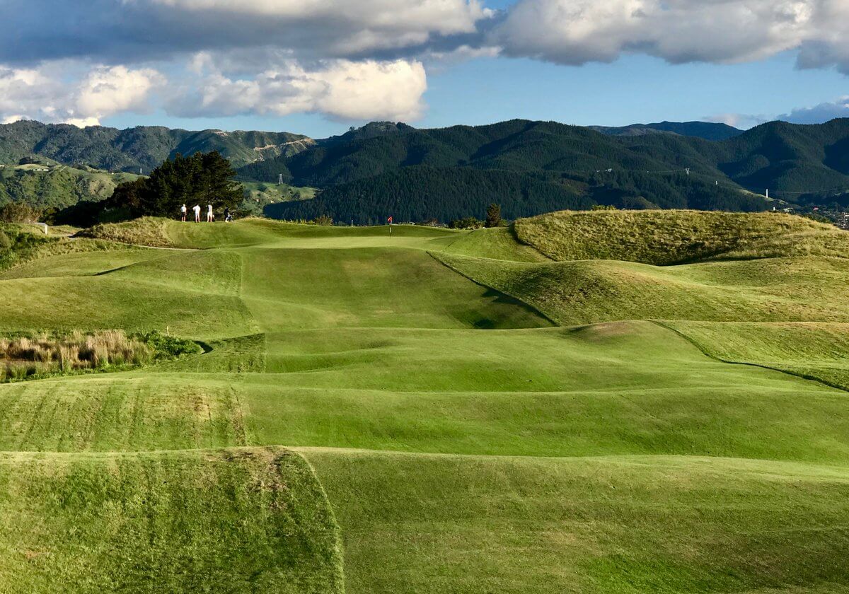 Image displaying golfers standing atop rolling terrain at Paraparaumu's Golf Links
