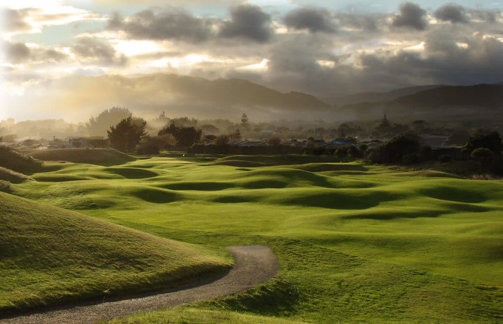 Dusk light intercedes mist over the links golf course at Paraparaumu Beach, New Zealand