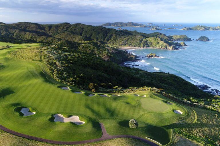 Aerial image displaying the Kauri Cliffs Golf Course and distant Bay of Islands in New Zealand