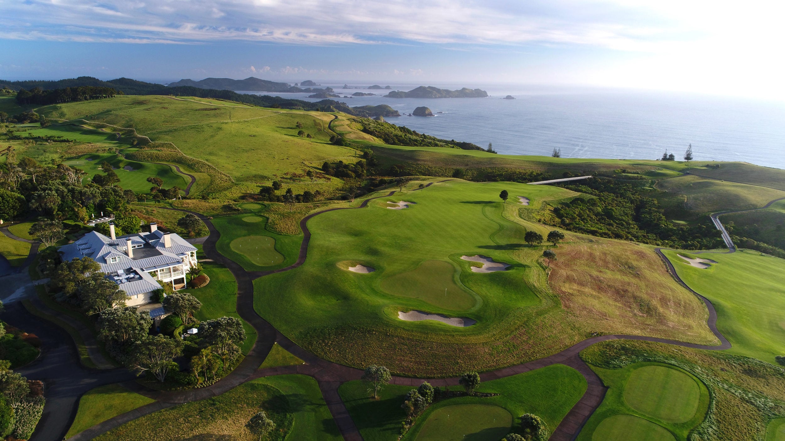 Aerial image of the clubhouse and surrounding golf course at Kauri Cliffs Resort