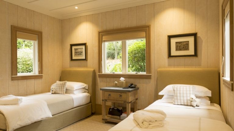 Image of two single beds in a suite at Kauri Cliffs Golf Resort
