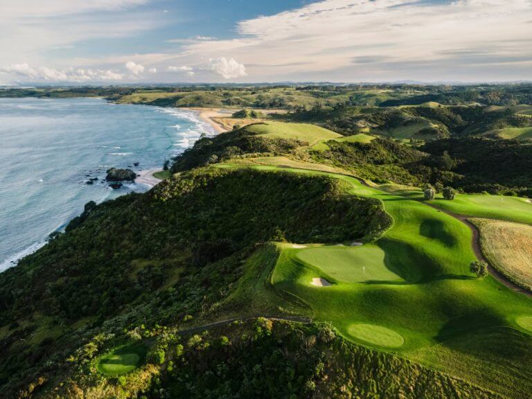 Aerial image of the Kauri Cliffs golf course and undulating hills in the far distance