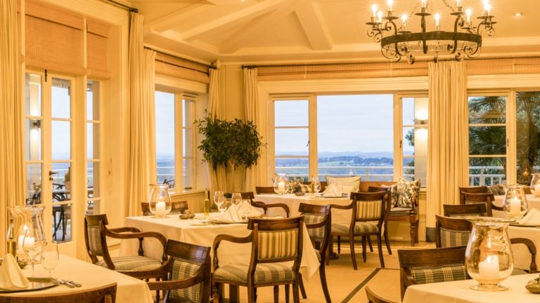 Image of a well-lit dining room at Kauri Cliffs Golf Resort in New Zealand's Matauri Bay