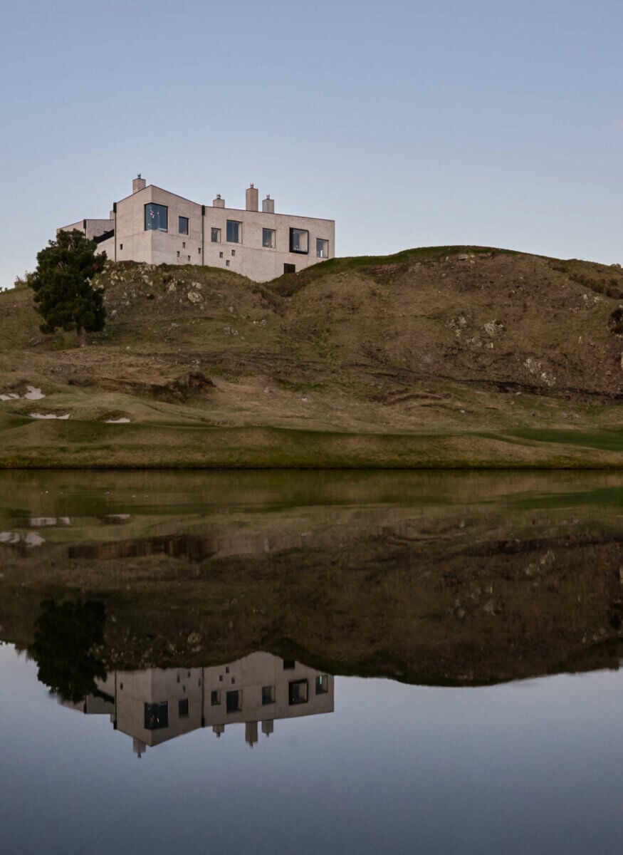 Portrait image of The Kinloch Club Resort building perched on top of a hill
