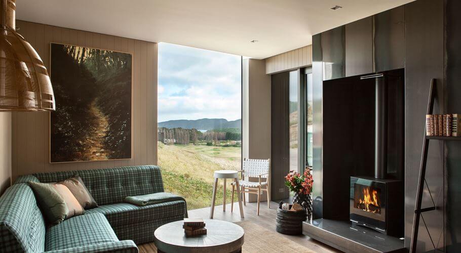 One-bedroom villa lounge with fireplace and view over The Kinloch Club Golf Course