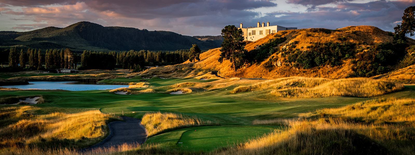 Overlooking the Kinloch Club golf course and main manor with forested hills in background at dusk