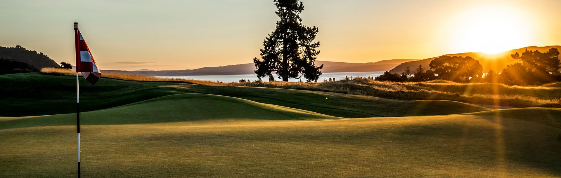 Dusk view looking from a green to the distant lake Taupo at The Kinloch Club Golf Resort